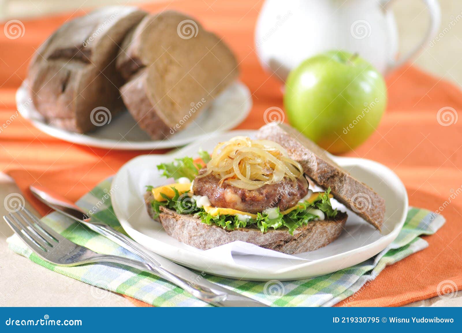 sweet corn burger with onion and vegetables on blue plate
